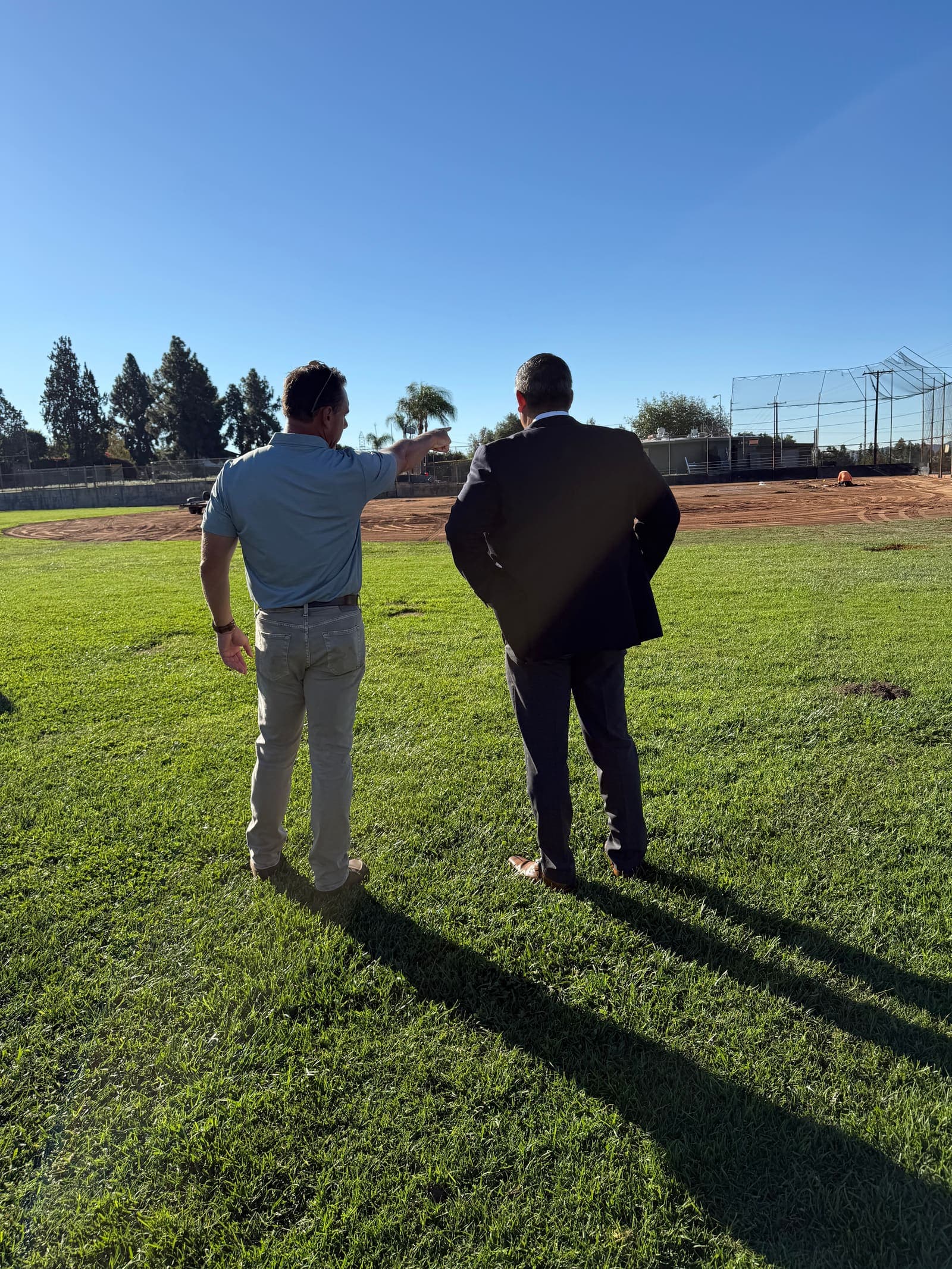 Community members gathered at Sutherland Fields with the San Gabriel mountains behind them.