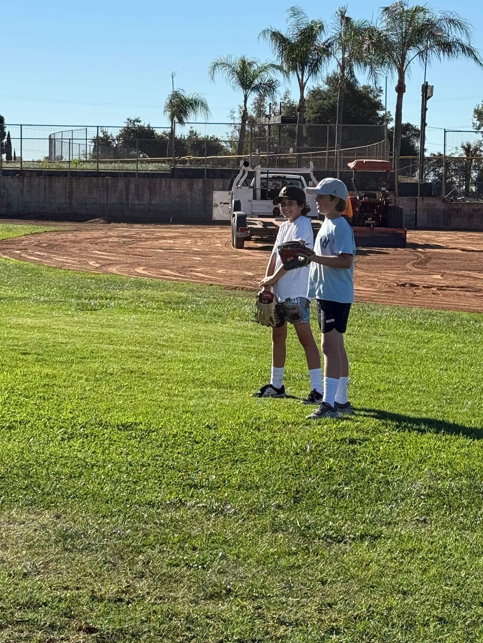 Two community members walking the perimeter of Sutherland Fields together.