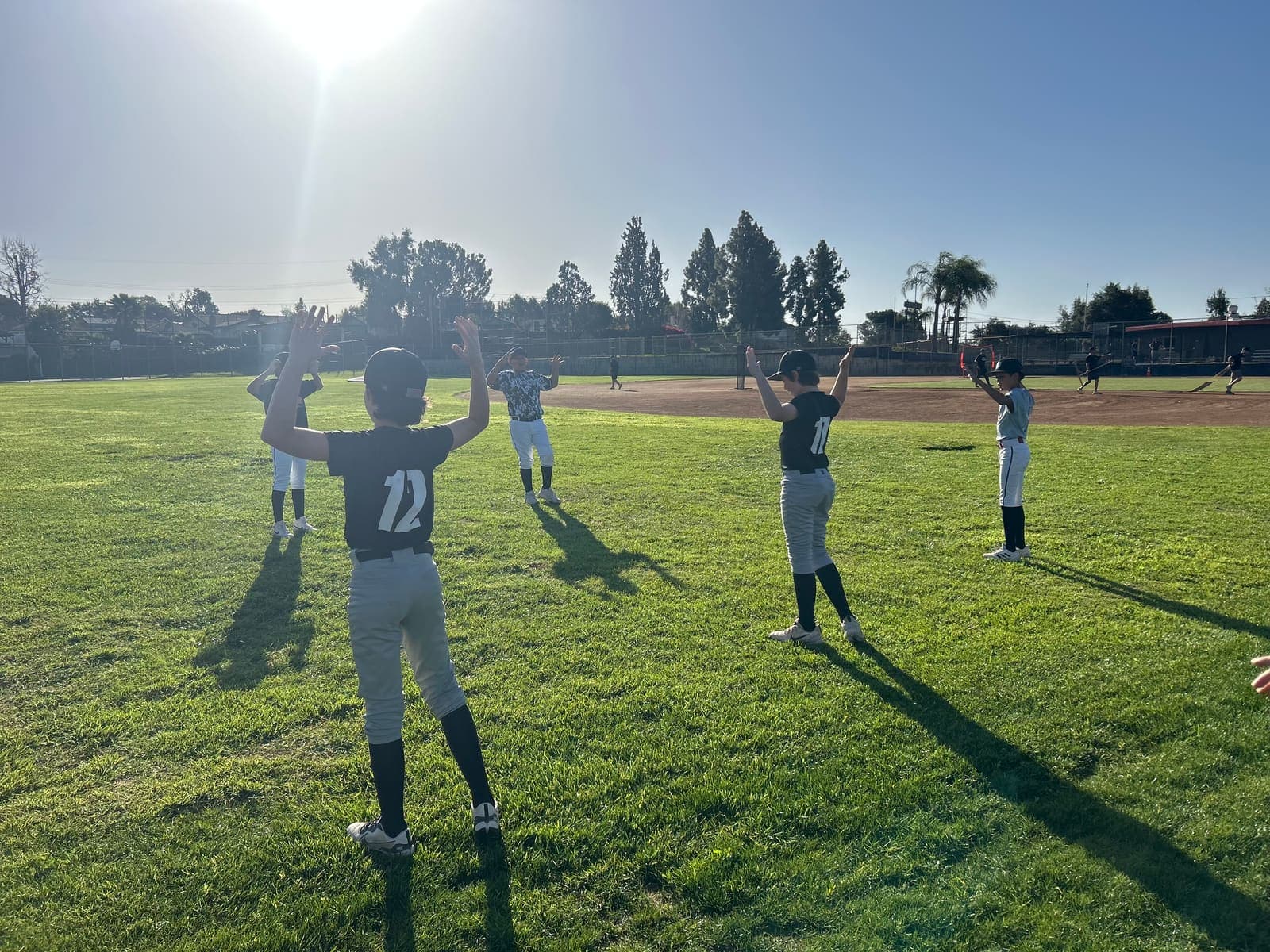 Young players in a pre-game warmup circle at Sutherland Fields.