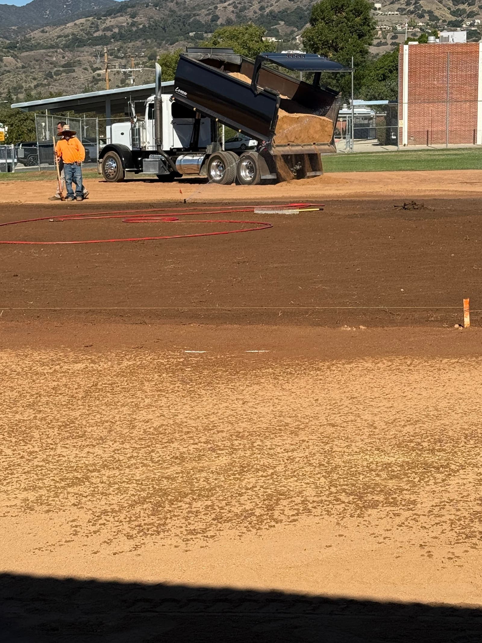 Restoration in progress — fresh dirt being delivered to rebuild the infield.
